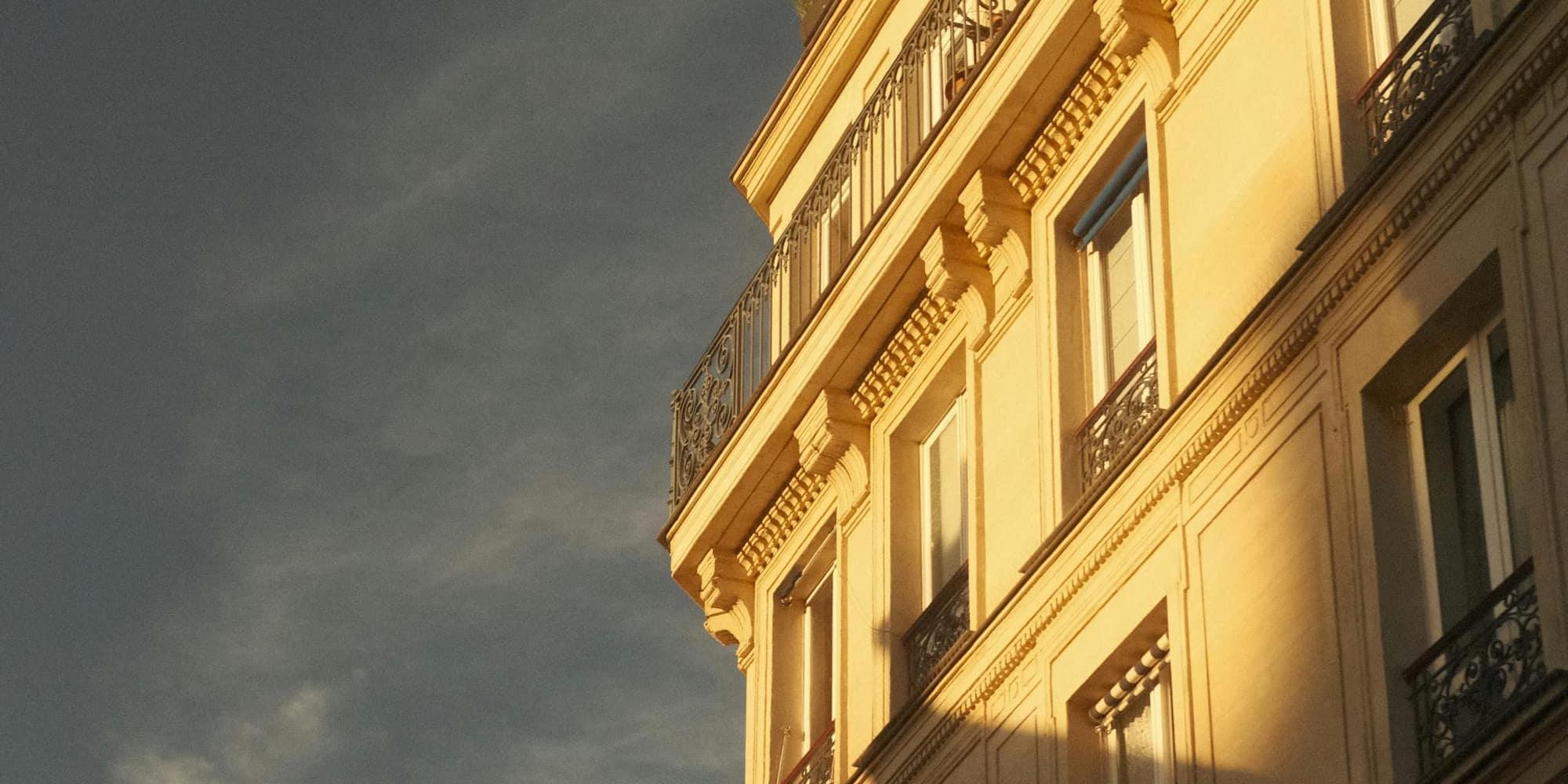 Elegant Parisian apartment building bathed in warm sunset light